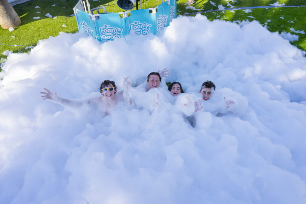 people enjoying a Blizzard Foam outdoor entertainment foam party in Houston Texas